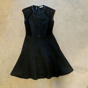 Black dress with leather trim. Fit and flare.